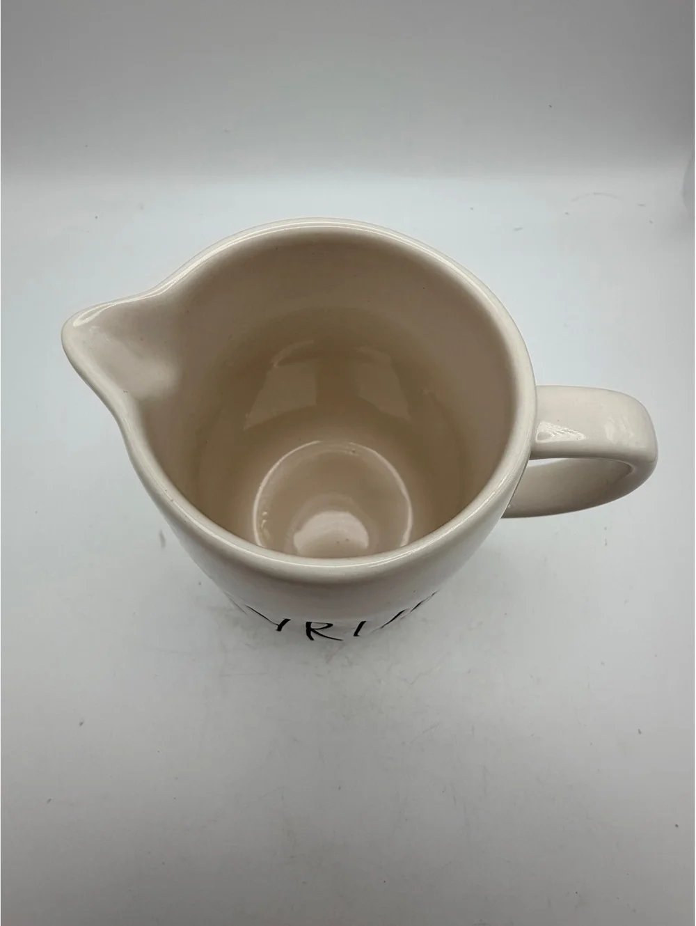 Rae Dunn white ceramic syrup pitcher.with handle. In like new condition